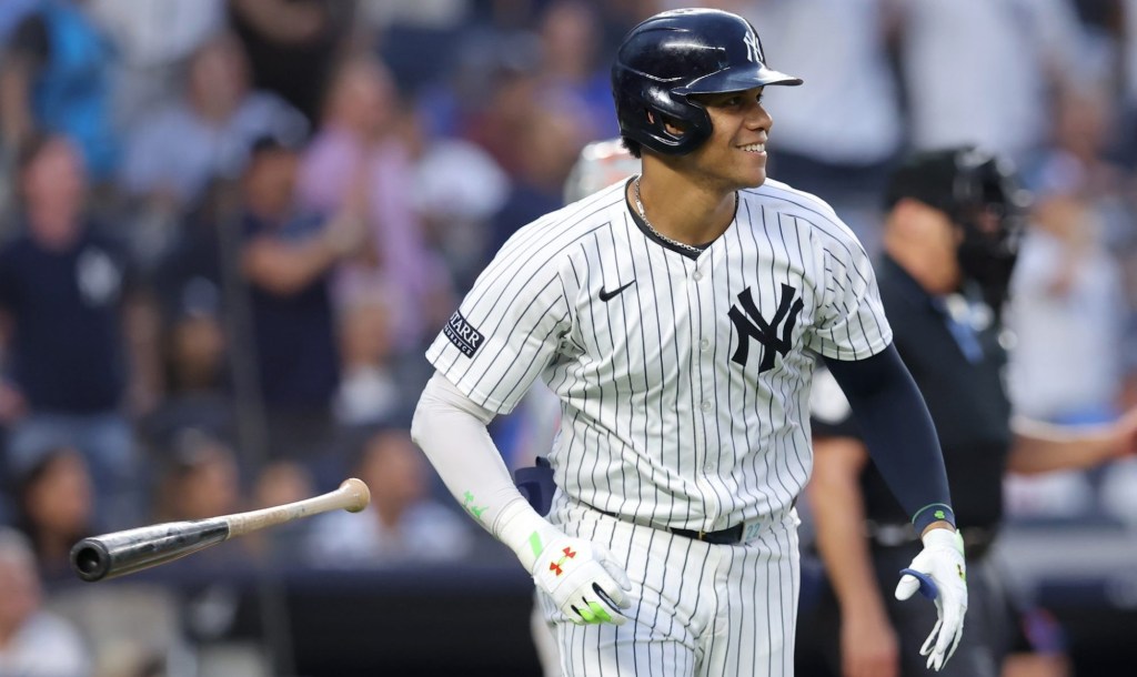 Jul 24, 2024; Bronx, New York, USA; New York Yankees right fielder Juan Soto (22) flips his bat after hitting a solo home run against the New York Mets during the third inning at Yankee Stadium.