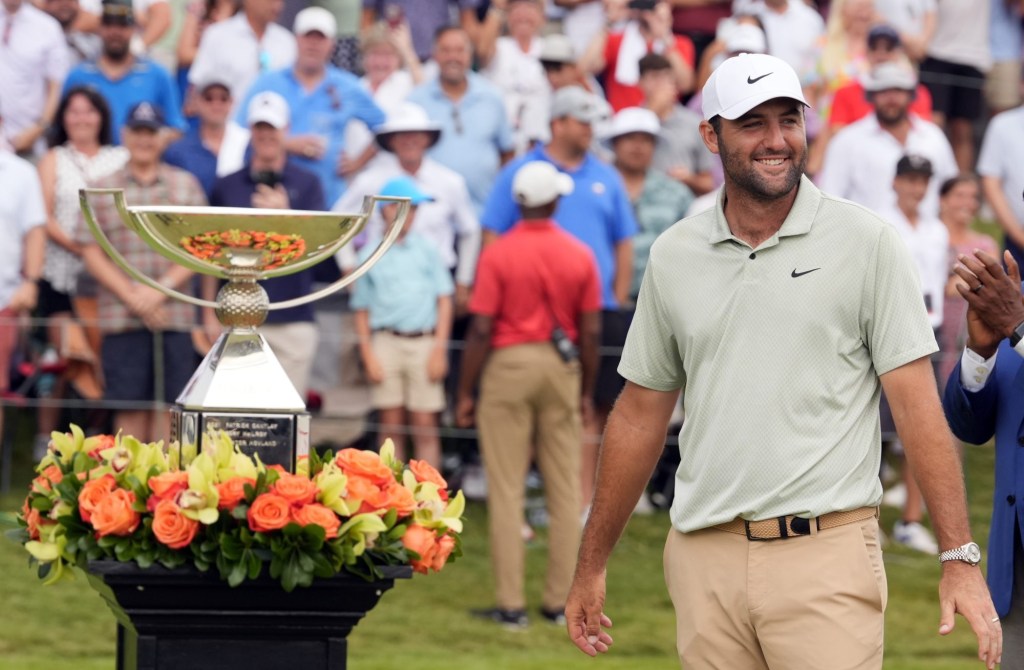 Sep 1, 2024; Atlanta, Georgia, USA; Scottie Scheffler celebrates winning the TOUR Championship golf tournament.