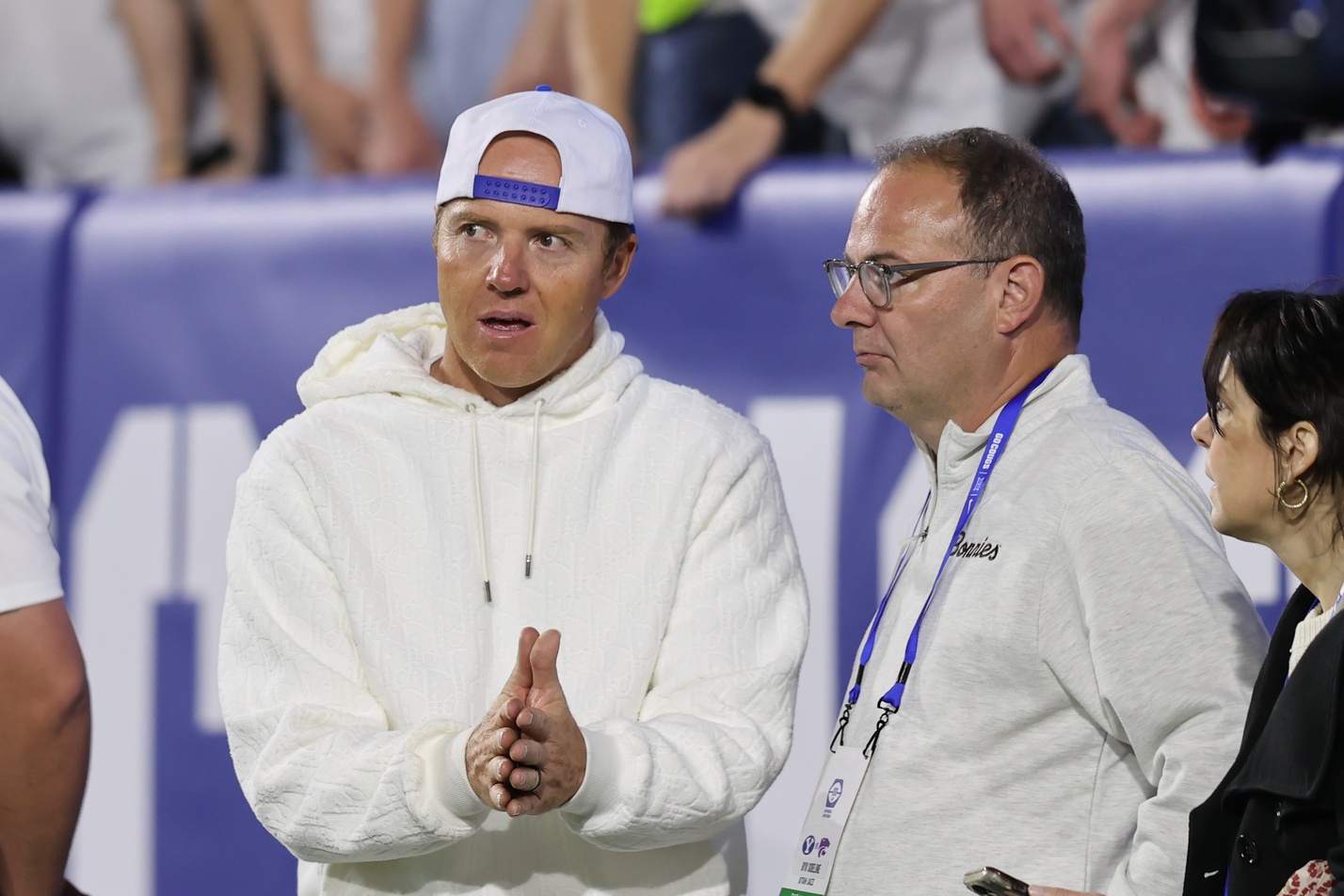 Sep 21, 2024; Provo, Utah, USA; Brigham Young Cougars alumni and Utah Jazz owner Ryan Smith speaks with Adrian Wojnarowski in the game against the Kansas State Wildcats at LaVell Edwards Stadium.