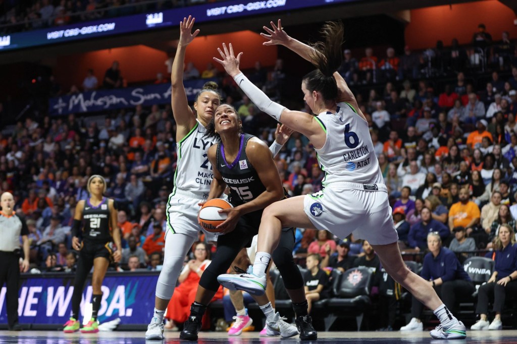 Oct 4, 2024; Uncasville, Connecticut, USA; Connecticut Sun forward Alyssa Thomas (25) defended by Minnesota Lynx forward Bridget Carleton (6) during the second half during game three of the 2024 WNBA Semi-finals at Mohegan Sun Arena.