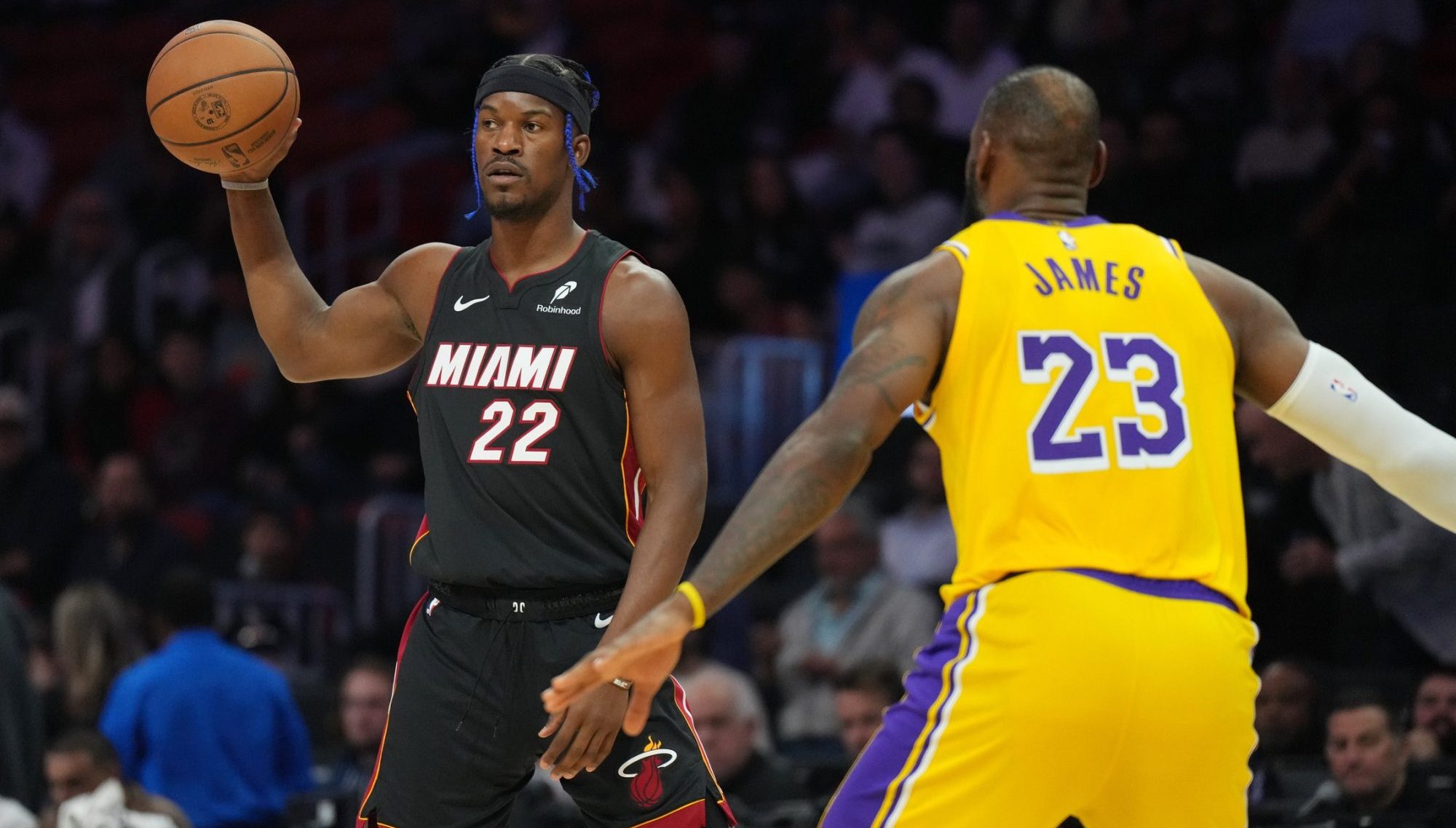 Dec 4, 2024; Miami, Florida, USA; Miami Heat forward Jimmy Butler (22) looks to pass against Los Angeles Lakers forward LeBron James (23) in the first half at Kaseya Center.