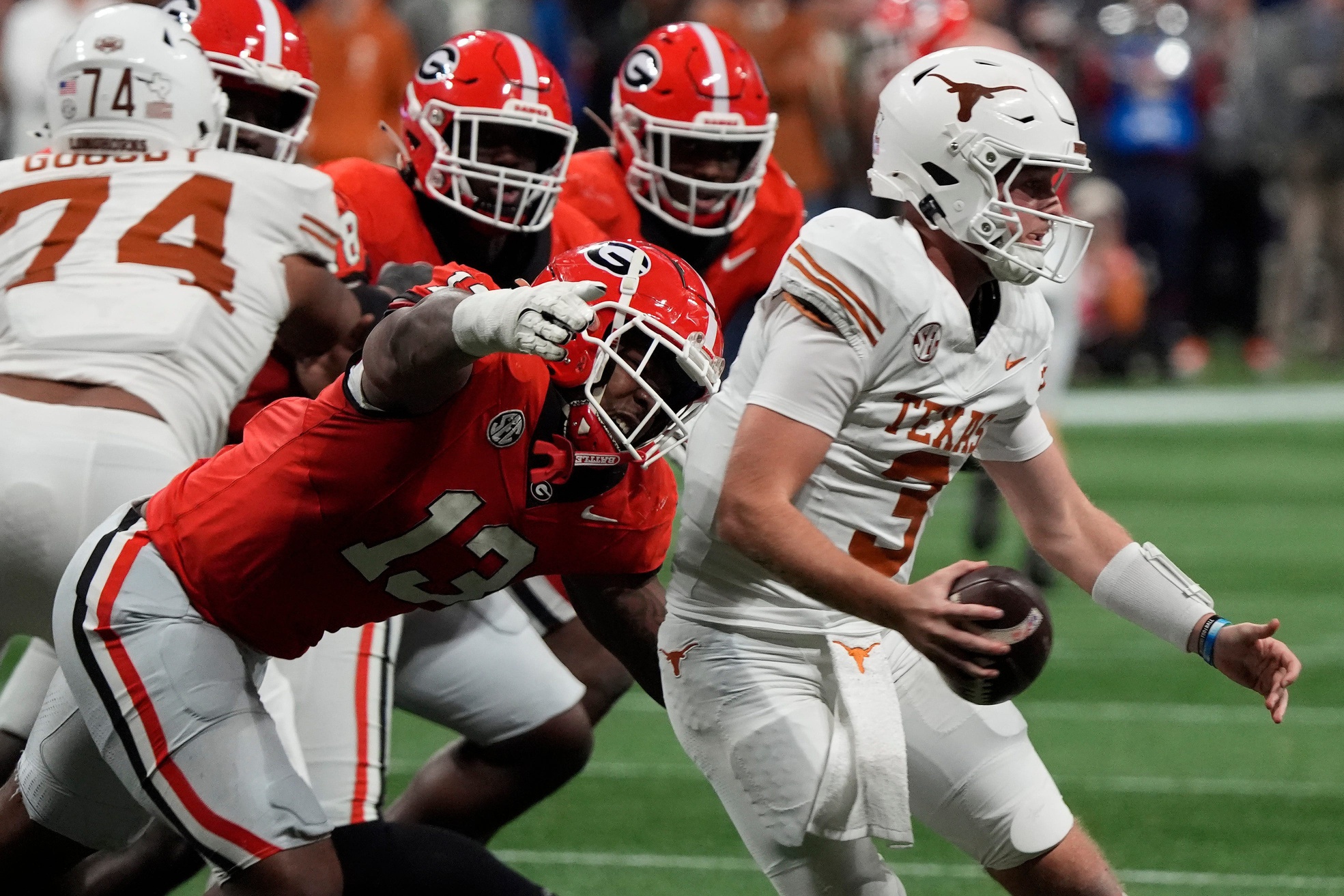 Georgia defensive lineman Mykel Williams (13) goes in for a sack on Texas quarterback Quinn Ewers (3) during the second half of the SEC championship game against Texas in Atlanta, on Saturday, Dec. 7, 2024.