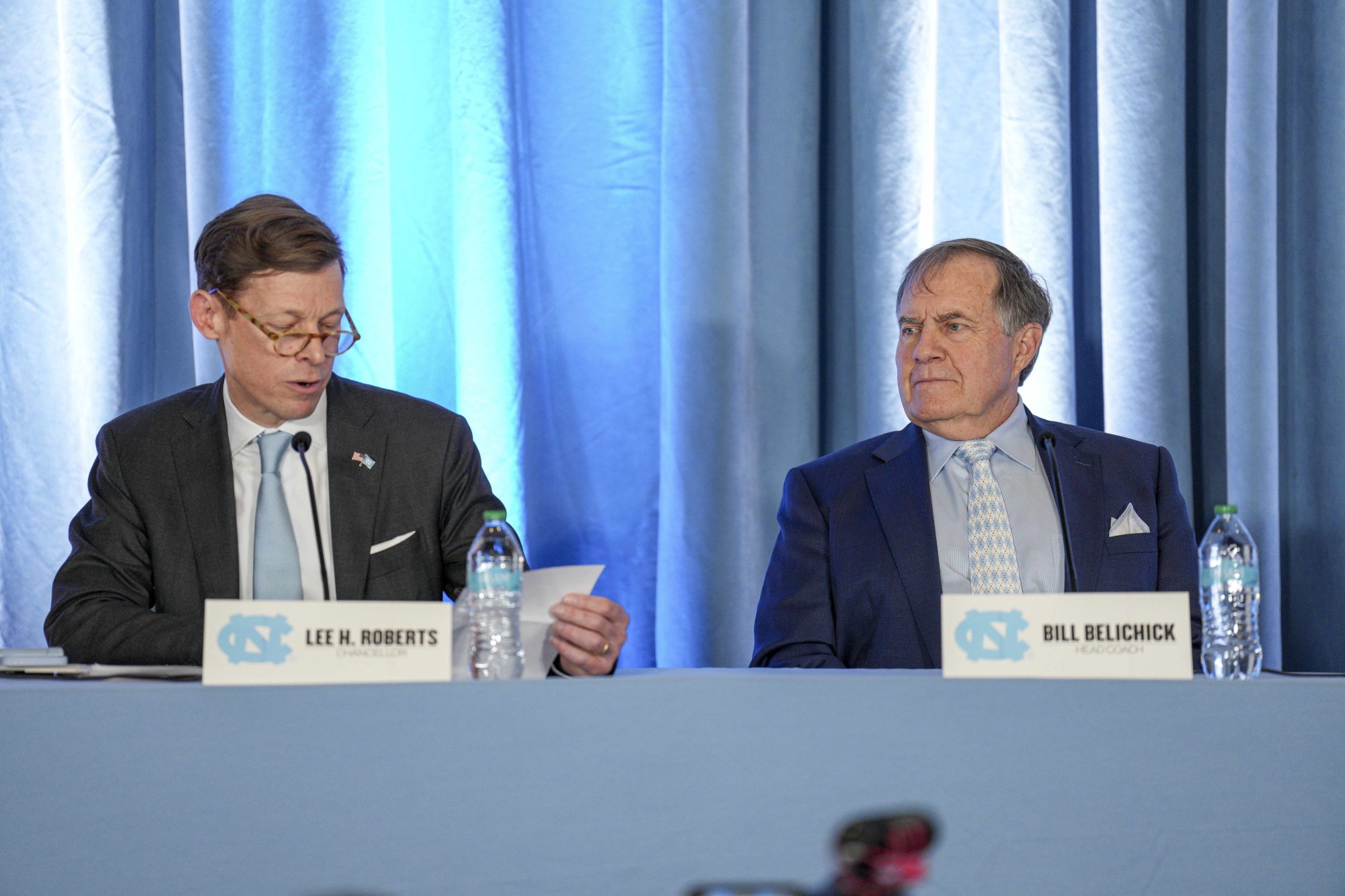 Dec 12, 2024; Chapel Hill, NC, USA; North Carolina Tar Heels chancellor Lee Roberts reads a transcript about new head coach Bill Belichicks father who served as an assistant coach at New North Carolina Tar Heels new in 1954 at Loudermilk Center for Excellence.