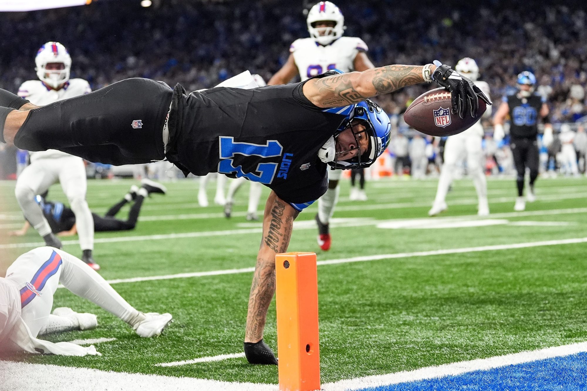 Detroit Lions wide receiver Tim Patrick (17) dives for a touchdown against Buffalo Bills cornerback Christian Benford (47) during the first half at Ford Field in Detroit on Sunday, Dec. 15, 2024.