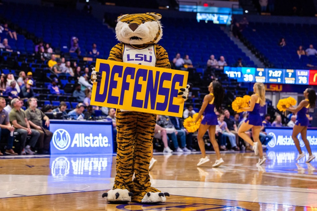 Dec 17, 2024; Baton Rouge, Louisiana, USA; LSU Tigers mascot Mike the Tiger holds up a defense sign behind the Stetson Hatters team on a time out during the second half at Pete Maravich Assembly Center.