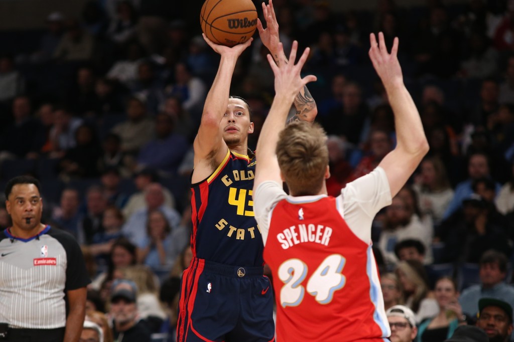 Dec 19, 2024; Memphis, Tennessee, USA; Golden State Warriors forward Lindy Waters III (43) shoots for three as Memphis Grizzlies guard Cam Spencer (24) defends during the fourth quarter at FedExForum.