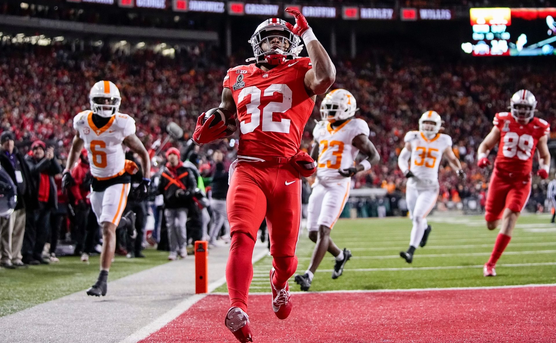 Ohio State Buckeyes running back TreVeyon Henderson (32) runs for a touchdown during the first half of the College Football Playoff first round game against the Tennessee Volunteers at Ohio Stadium in Columbus on Dec. 21, 2024.