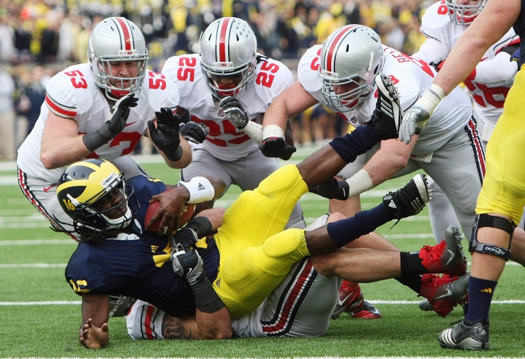 Ohio State Buckeyes defensive tackle John Simon (54) sacks Michigan Wolverines quarterback Denard Robinson (16) in the first half of their NCAA football game between Ohio State and Michigan at Michigan Stadium in Ann Arbor, November 26, 2011. (Dispatch photo by Neal C. Lauron)