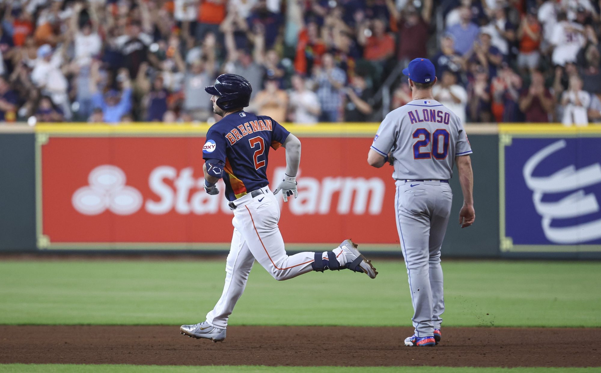 Jun 20, 2023; Houston, Texas, USA; New York Mets first baseman Pete Alonso (20) looks on as Houston Astros third baseman Alex Bregman (2) rounds the bases after hitting a home run during the third inning at Minute Maid Park.