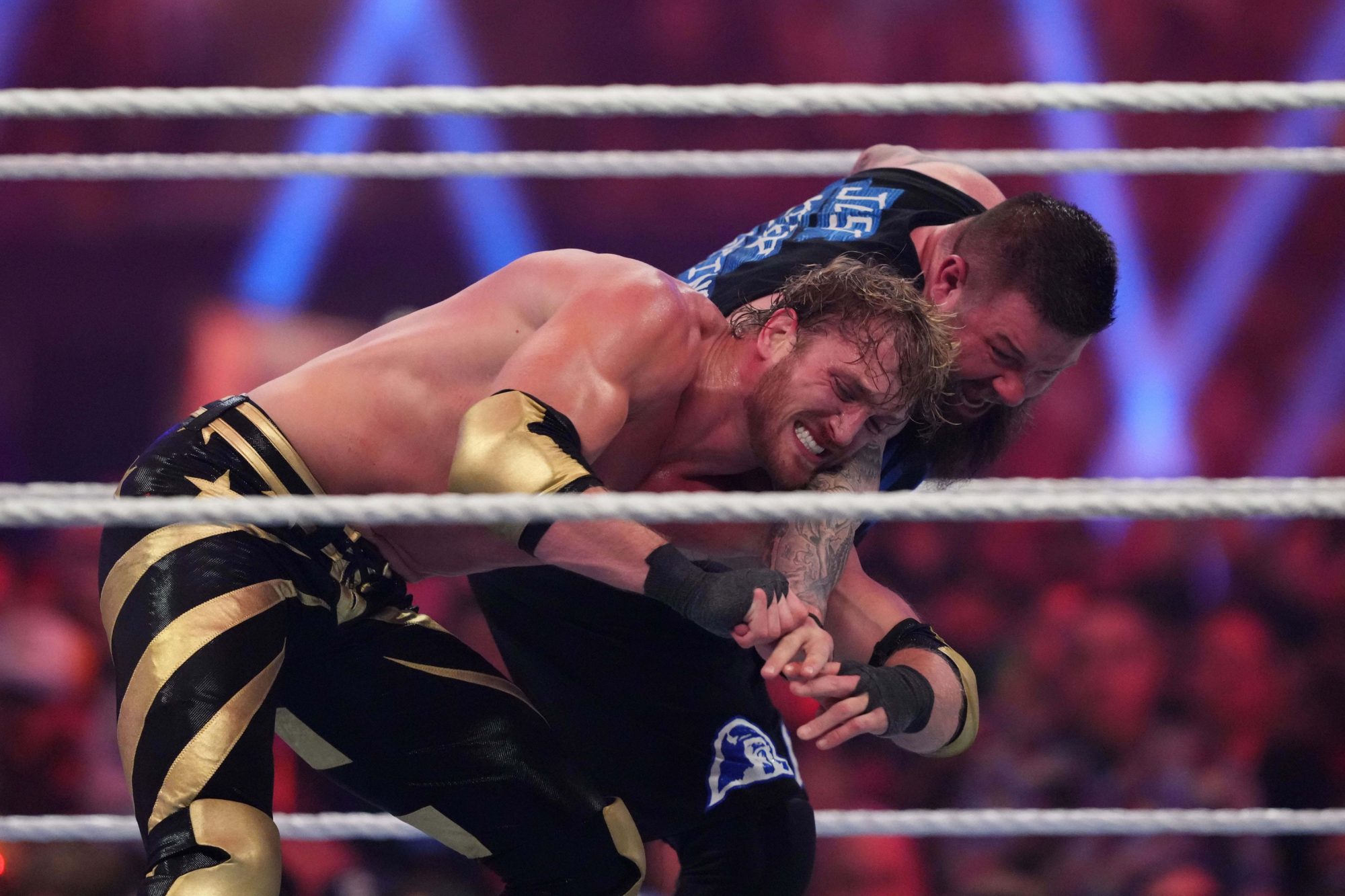 Jan 27, 2024; St. Petersburg, FL, USA; Kevin Owens (black attire) and Logan Paul (gold attire) battle during the United States Championship match during the Royal Rumble at Tropicana Field.