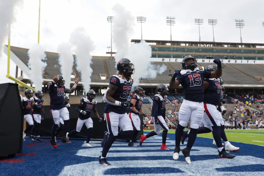 Mar 31, 2024; Houston, TX, USA; Houston Roughnecks running back Tiyon Evans (13) leads the Houston Roughnecks onto the field before a game against the Memphis Showboats at Rice Stadium