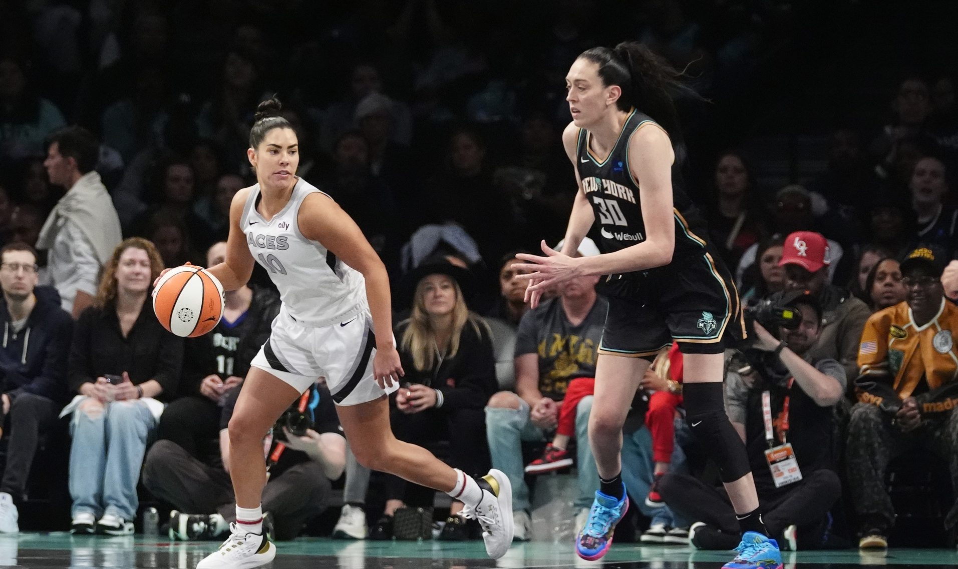 Sep 29, 2024; Brooklyn, New York, USA; Las Vegas Aces guard Kelsey Plum (10) dribbles the ball against New York Liberty forward Breanna Stewart (30) during game one of the 2024 WNBA Semi-finals at Barclays Center.