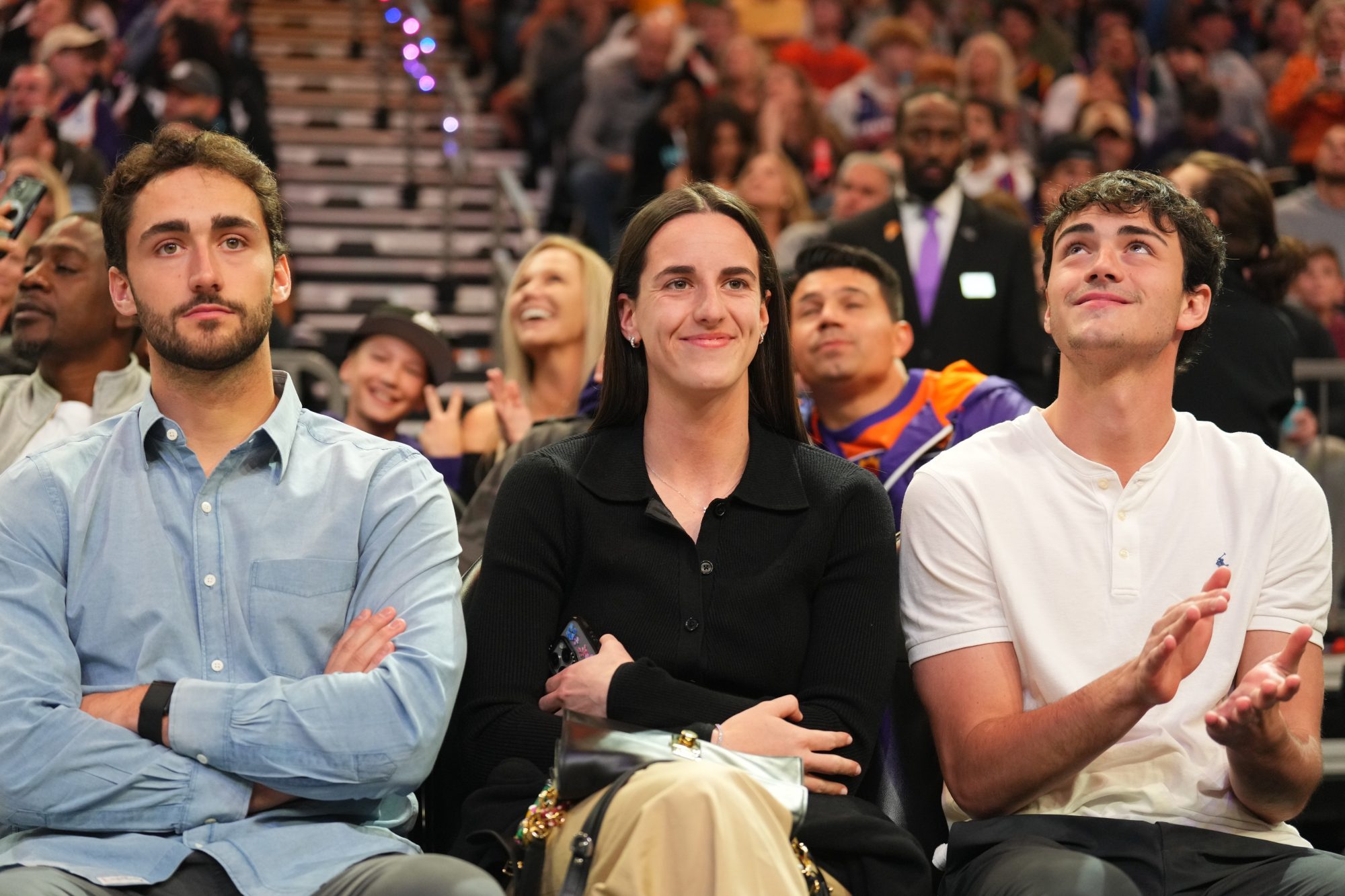 Nov 30, 2024; Phoenix, Arizona, USA; Indiana Fever player Caitlin Clark attends the game between the Phoenix Suns and the Golden State Warriors during the first half at Footprint Center.