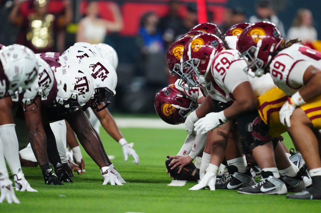 Dec 27, 2024; Las Vegas, NV, USA; Helmets at the line fo scrimmage as DUPLICATE***Southern California Trojans long snapper Hank Pepper (31) snaps the ball against the Texas A&M Aggies at Allegiant Stadium.