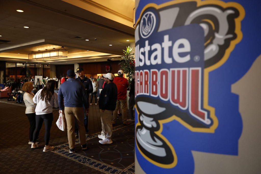 Jan 1, 2025; New Orleans, LA, USA; Fans line at the front desk of the Sheraton hotel after the Sugar Bowl CFP quarterfinal between Georgia and Notre Dame was postponed after an attack on Bourbon Street.