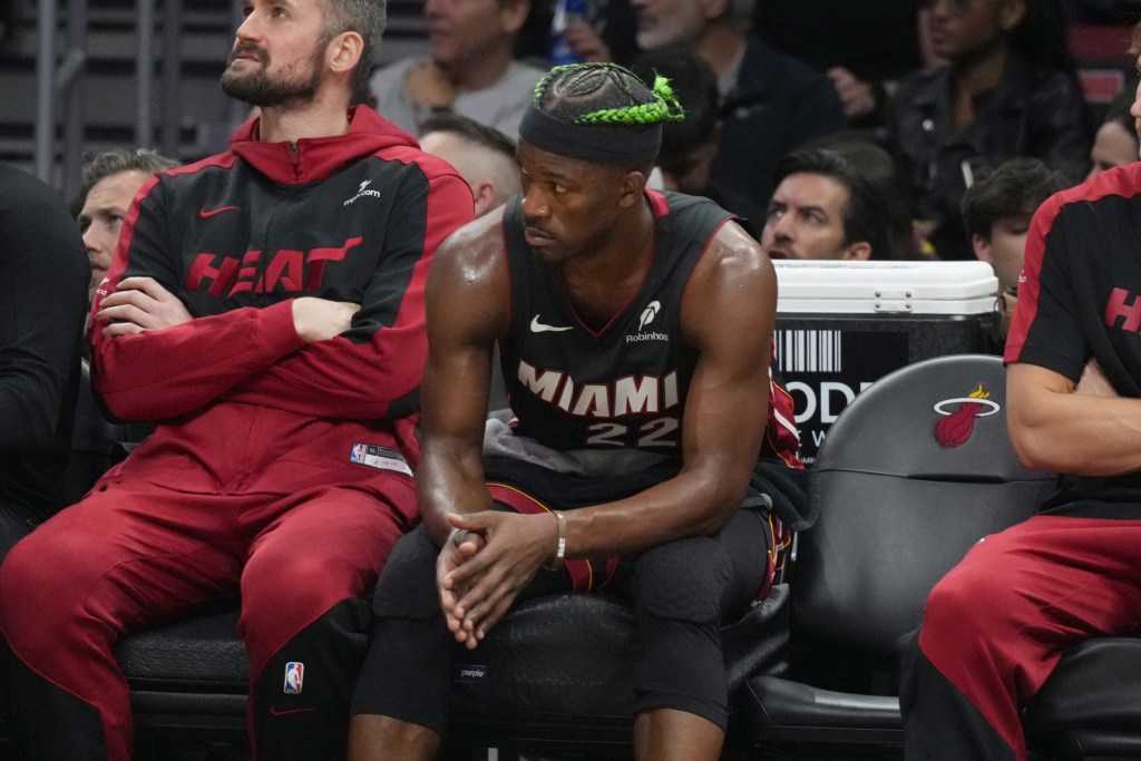 Jan 2, 2025; Miami, Florida, USA; Miami Heat forward Jimmy Butler (22) looks on from the bench during the second half at Kaseya Center.