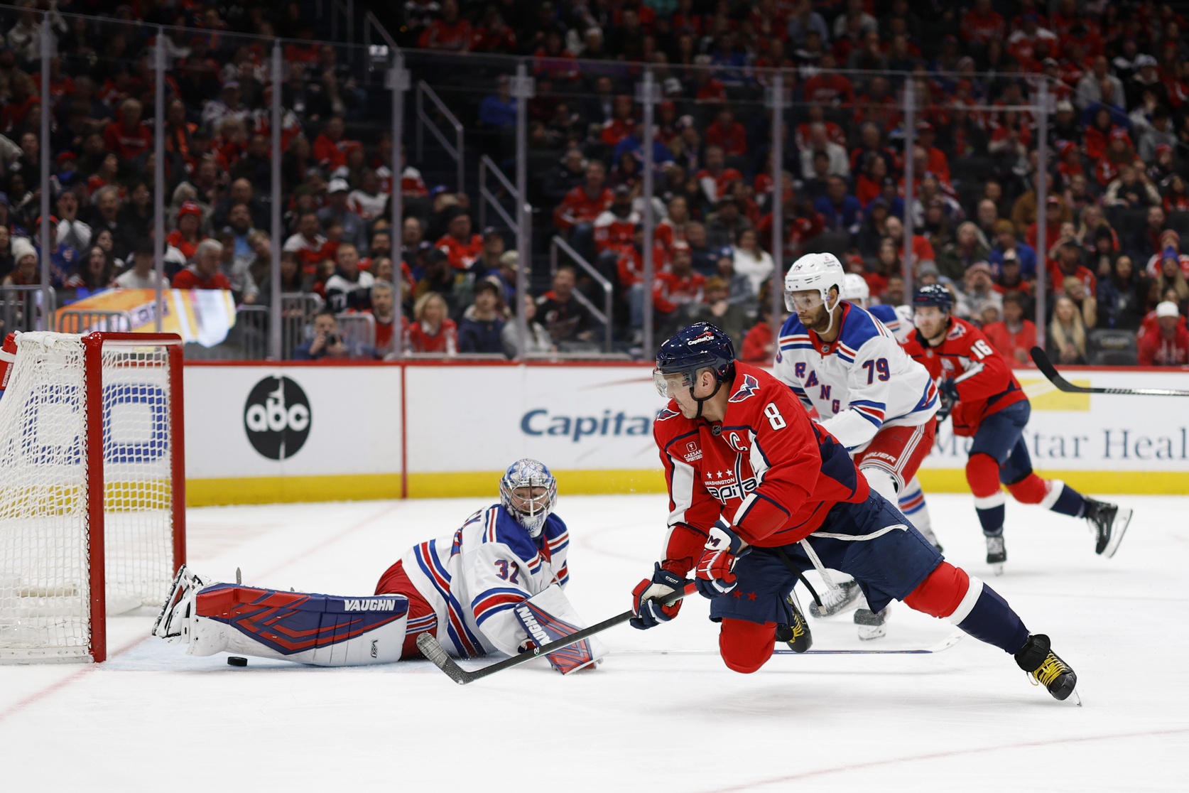 Jan 4, 2025; Washington, District of Columbia, USA; Washington Capitals left wing Alex Ovechkin (8) scores a goal on New York Rangers goaltender Jonathan Quick (32) in the third period at Capital One Arena.