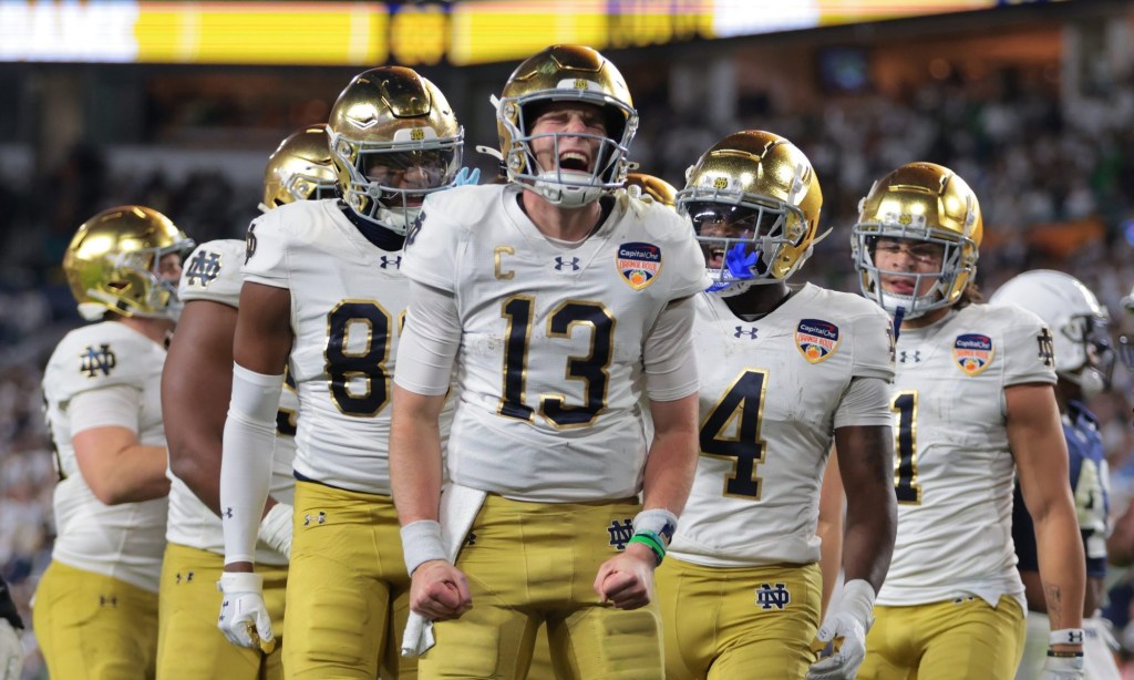 Jan 9, 2025; Miami, FL, USA; Notre Dame Fighting Irish quarterback Riley Leonard (13) celebrates a touch down with teammates in the second half against the Penn State Nittany Lions in the Orange Bowl at Hard Rock Stadium.