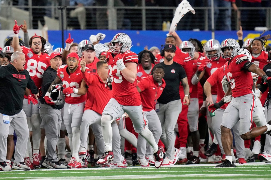 Ohio State Buckeyes defensive end Jack Sawyer (33) knocks the ball out of the hands of Texas Longhorns quarterback Quinn Ewers (3) and returns the fumble for a touchdown in the fourth quarter of the Cotton Bowl Classic during the College Football Playoff semifinal game at AT&T Stadium in Arlington, Texas on January, 10, 2025.