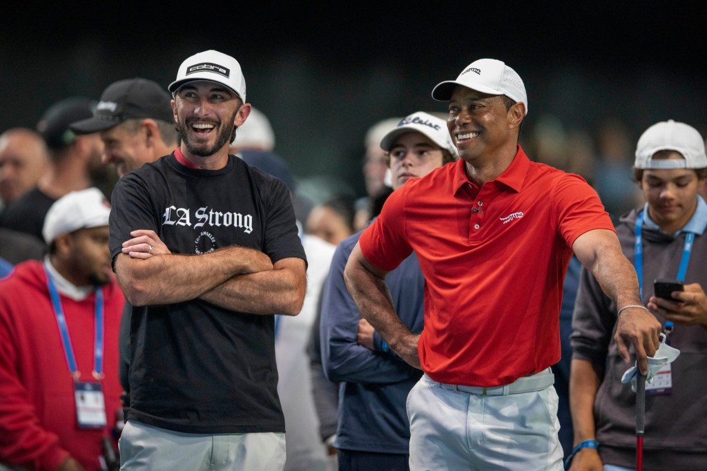 Golfers Max Homa , left, and Tiger Woods laugh as they warm up for their match at SoFi Center, the home of TGL, the interactive golf league founded by Tiger Woods and SoFi Center, the home of TGL, the interactive golf league founded by Tiger Woods and Rory McIlroy on January 14, 2025 in Palm Beach Gardens, Florida.