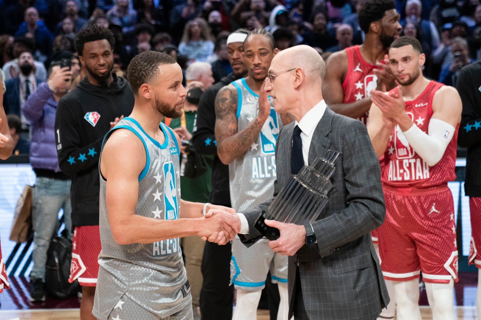 February 20, 2022; Cleveland, Ohio, USA; NBA commissioner Adam Silver (right) presents Team LeBron guard Stephen Curry of the Golden State Warriors (30) with the The Kobe Bryant Trophy for being the most valuable player after the 2022 NBA All-Star Game at Rocket Mortgage FieldHouse.