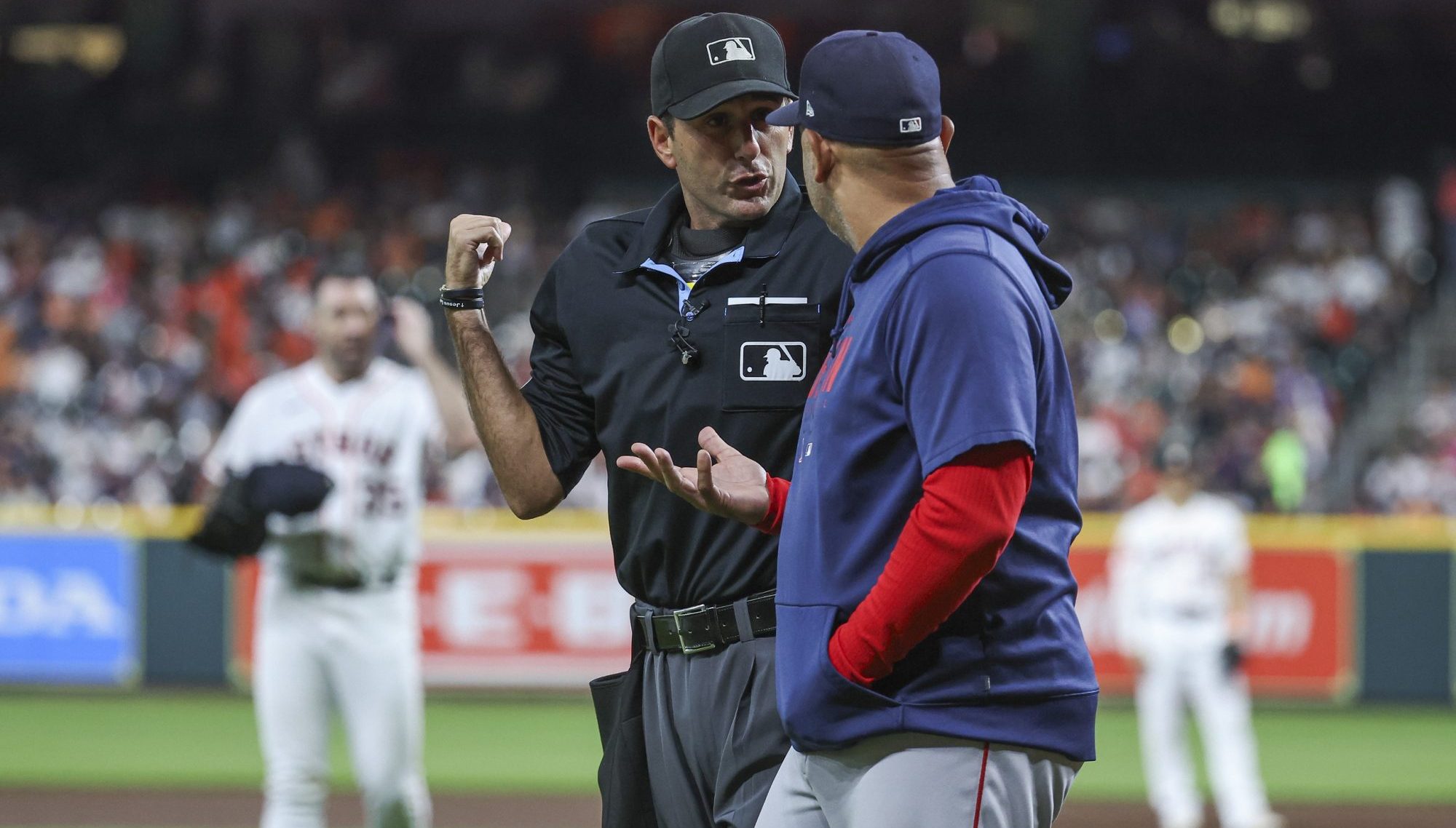 Aug 22, 2023; Houston, Texas, USA; Boston Red Sox manager Alex Cora (13) talks with home plate umpire Pat Hoberg as Houston Astros starting pitcher Justin Verlander (35) adjusts his PitchCom device during the second inning at Minute Maid Park.