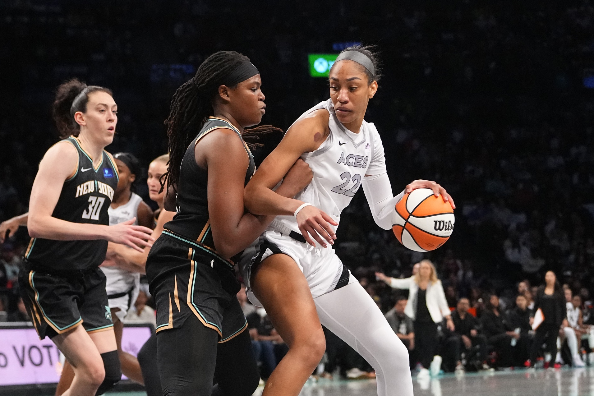 Sep 29, 2024; Brooklyn, New York, USA; Las Vegas Aces center A'ja Wilson (22) dribbles the ball against New York Liberty forward Jonquel Jones (35) during game one of the 2024 WNBA Semi-finals at Barclays Center.