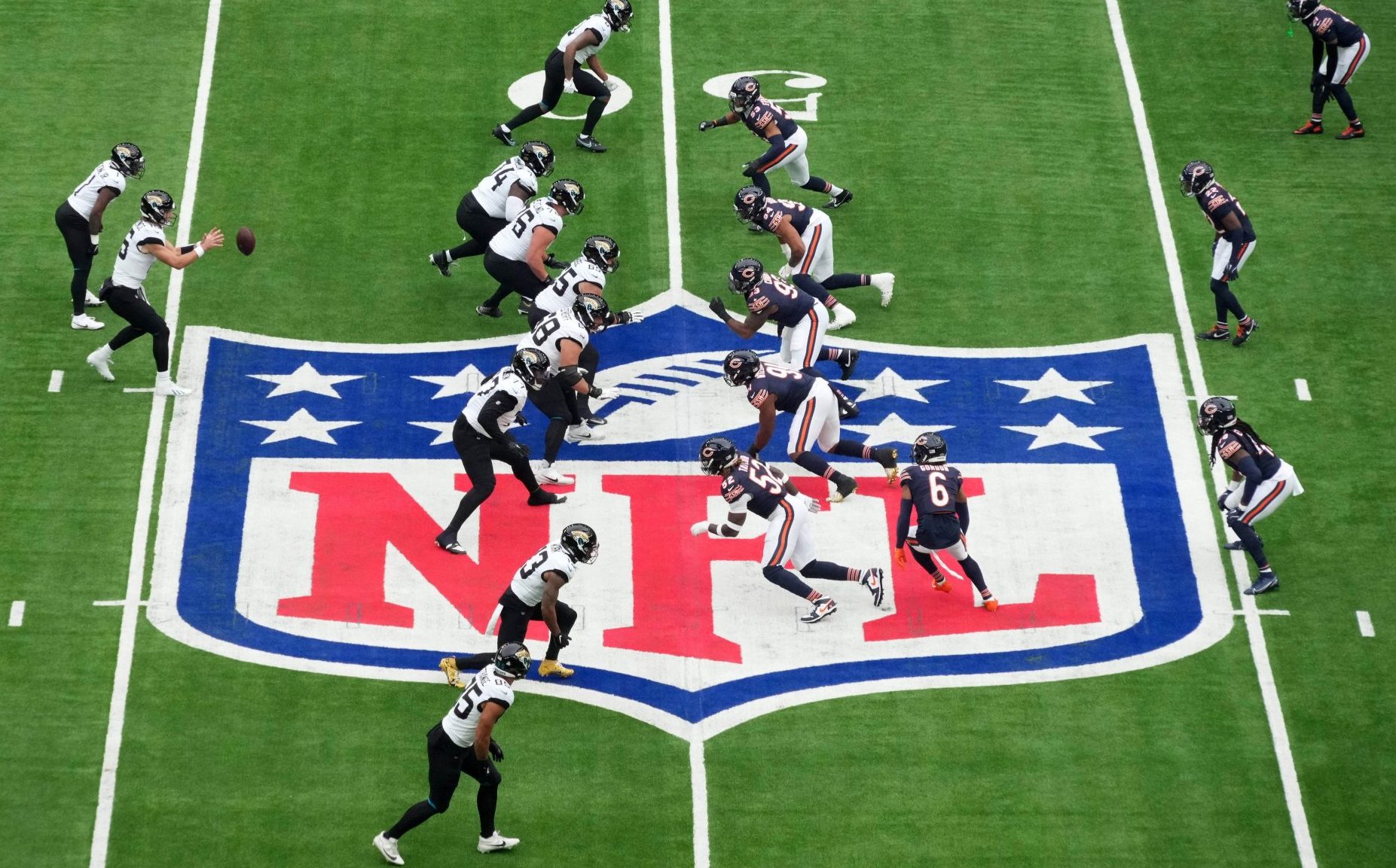 Oct 13, 2024; London, United Kingdom; A general view as Jacksonville Jaguars quarterback Trevor Lawrence (16) prepares to take the snap against the Chicago Bears on the NFL shield logo during an NFL International Series game at Tottenham Hotspur Stadium.