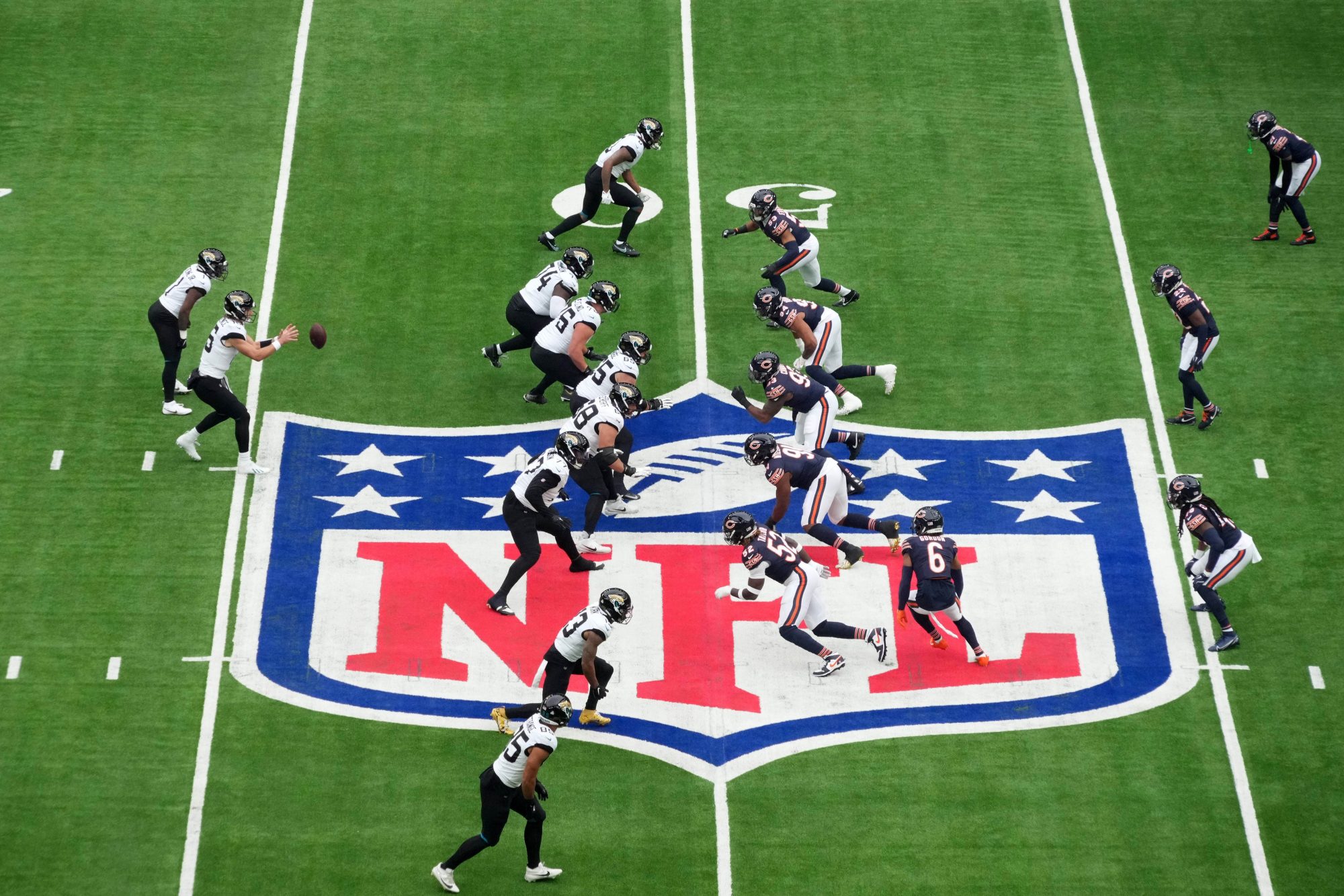 Oct 13, 2024; London, United Kingdom; A general view as Jacksonville Jaguars quarterback Trevor Lawrence (16) prepares to take the snap against the Chicago Bears on the NFL shield logo during an NFL International Series game at Tottenham Hotspur Stadium.