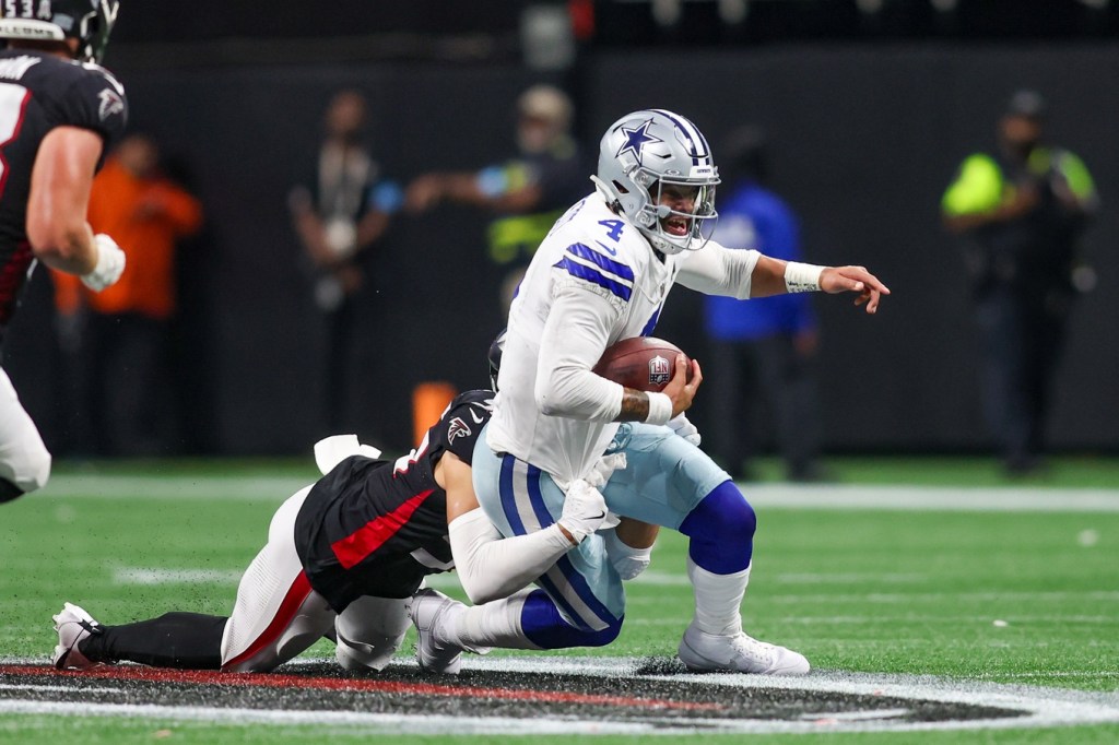 Nov 3, 2024; Atlanta, Georgia, USA; Dallas Cowboys quarterback Dak Prescott (4) scrambles against the Atlanta Falcons in the third quarter at Mercedes-Benz Stadium.