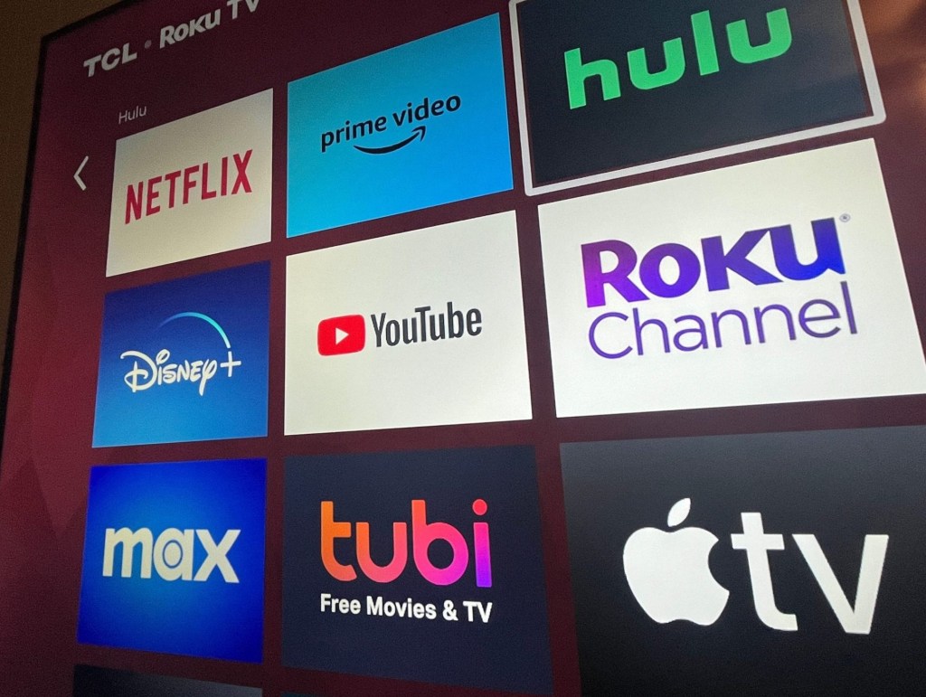 Multiple streaming services appear on a Roku TV.