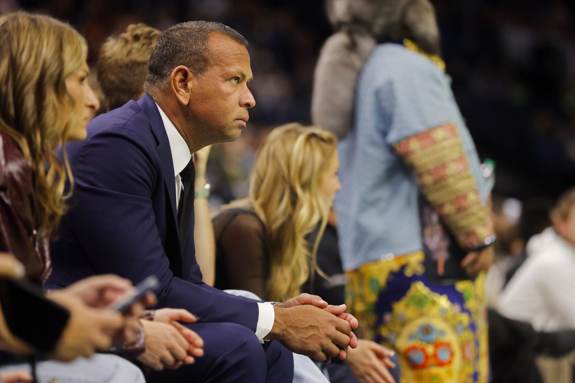 Nov 26, 2024; Minneapolis, Minnesota, USA; Alex Rodriguez watches as the Minnesota Timberwolves lose to the Houston Rockets in overtime at Target Center.