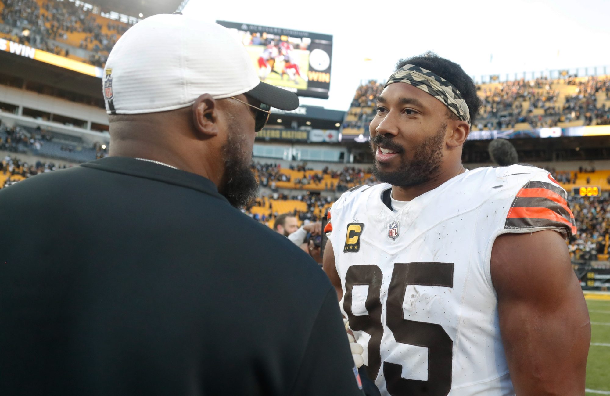 Dec 8, 2024; Pittsburgh, Pennsylvania, USA; Pittsburgh Steelers head coach Mike Tomlin (left) and Cleveland Browns defensive end Myles Garrett (95) talk after playing at Acrisure Stadium.