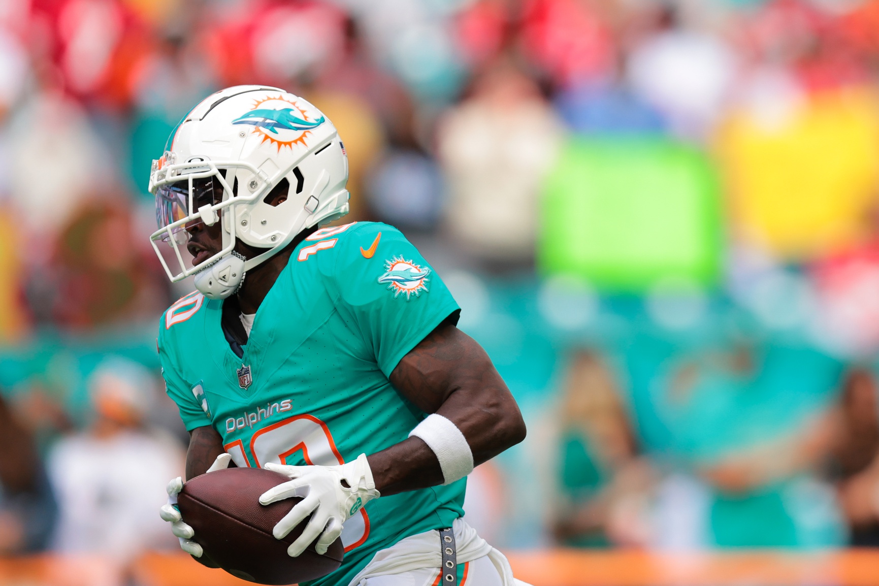 Dec 22, 2024; Miami Gardens, Florida, USA; Miami Dolphins wide receiver Tyreek Hill (10) runs with the football before the game against the San Francisco 49ers at Hard Rock Stadium.