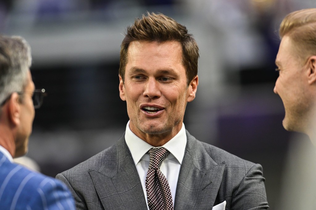 Dec 29, 2024; Minneapolis, Minnesota, USA; FOX broadcaster and former NFL quarterback Tom Brady looks on before the game between the Minnesota Vikings and the Green Bay Packers at U.S. Bank Stadium.