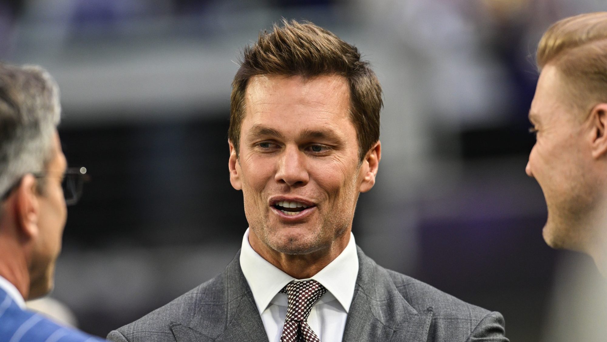 Dec 29, 2024; Minneapolis, Minnesota, USA; FOX broadcaster and former NFL quarterback Tom Brady looks on before the game between the Minnesota Vikings and the Green Bay Packers at U.S. Bank Stadium.