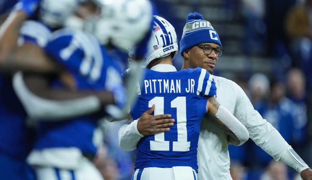 Indianapolis Colts quarterback Anthony Richardson (5) hugs Indianapolis Colts wide receiver Michael Pittman Jr. (11) on Sunday, Jan. 5, 2025, during pregame warm-up at Lucas Oil Stadium in Indianapolis.