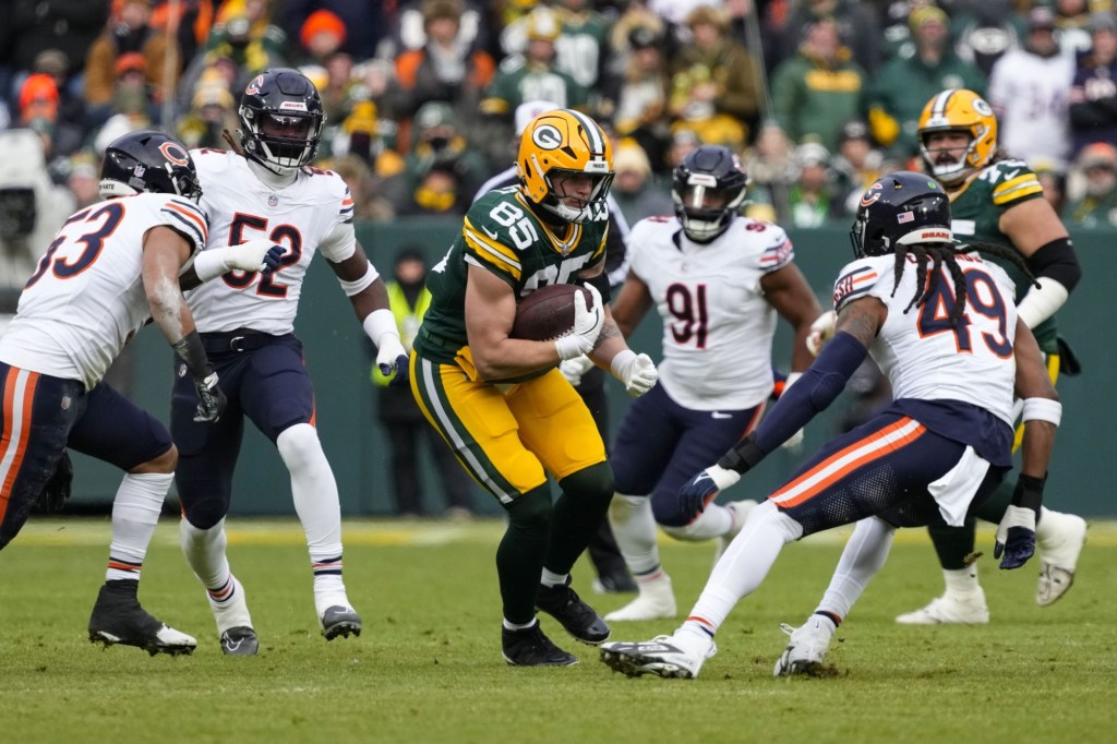 Jan 5, 2025; Green Bay, Wisconsin, USA; Green Bay Packers tight end Tucker Kraft (85) rushes with the football after catching a pass during the first quarter against the Chicago Bears at Lambeau Field.