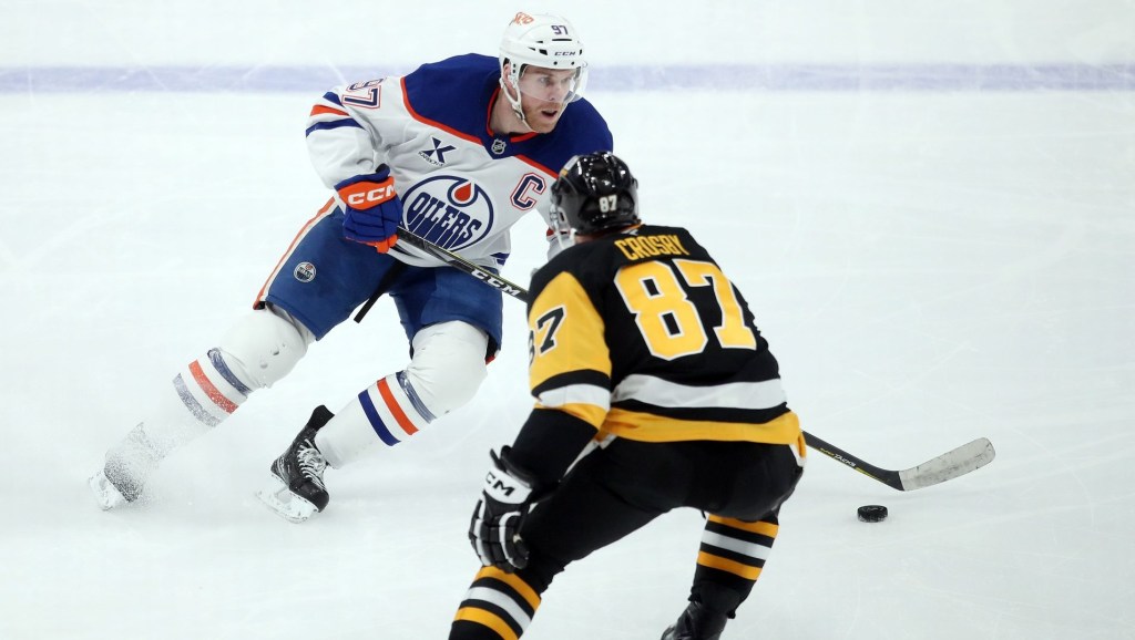 Jan 9, 2025; Pittsburgh, Pennsylvania, USA; Edmonton Oilers center Connor McDavid (97) skates with the puck as Pittsburgh Penguins center Sidney Crosby (87) defends during the third period at PPG Paints Arena