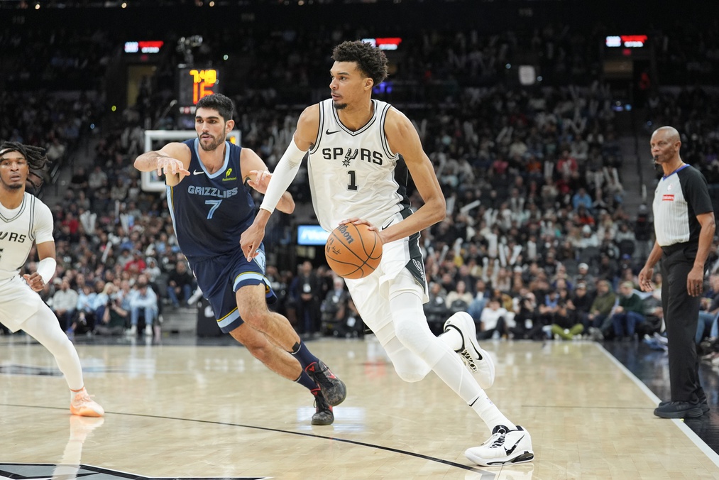 Jan 17, 2025; San Antonio, Texas, USA; San Antonio Spurs center Victor Wembanyama (1) dribbles past Memphis Grizzlies forward Santi Aldama (7) in the second half at Frost Bank Center.