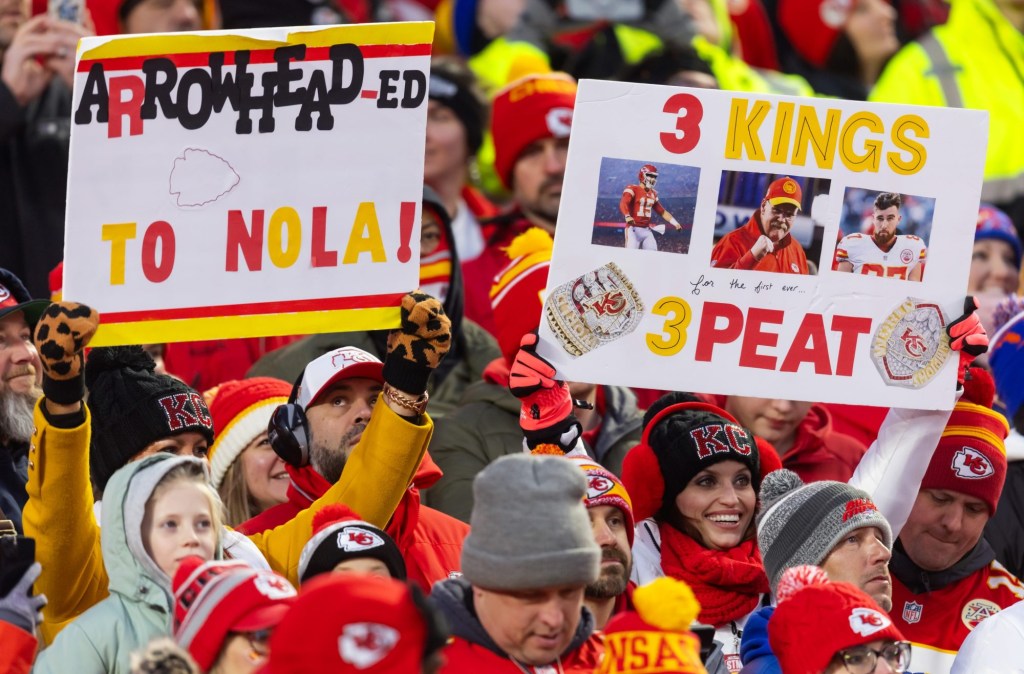 Jan 26, 2025; Kansas City, MO, USA; Kansas City Chiefs fan in the crowd holds a three peat sign against the Buffalo Bills during the AFC Championship game at GEHA Field at Arrowhead Stadium.