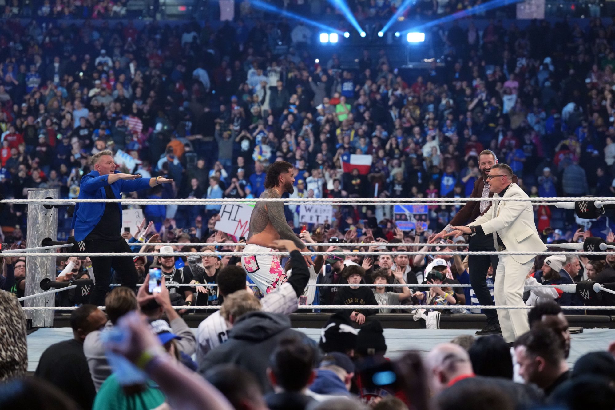 Feb 1, 2025; Indianapolis, IN, USA; Pat McAfee and Michael Cole and Wade Barrett celebrate with Jey Uso during the WWE Royal Rumble at Lucas Oil Stadium.