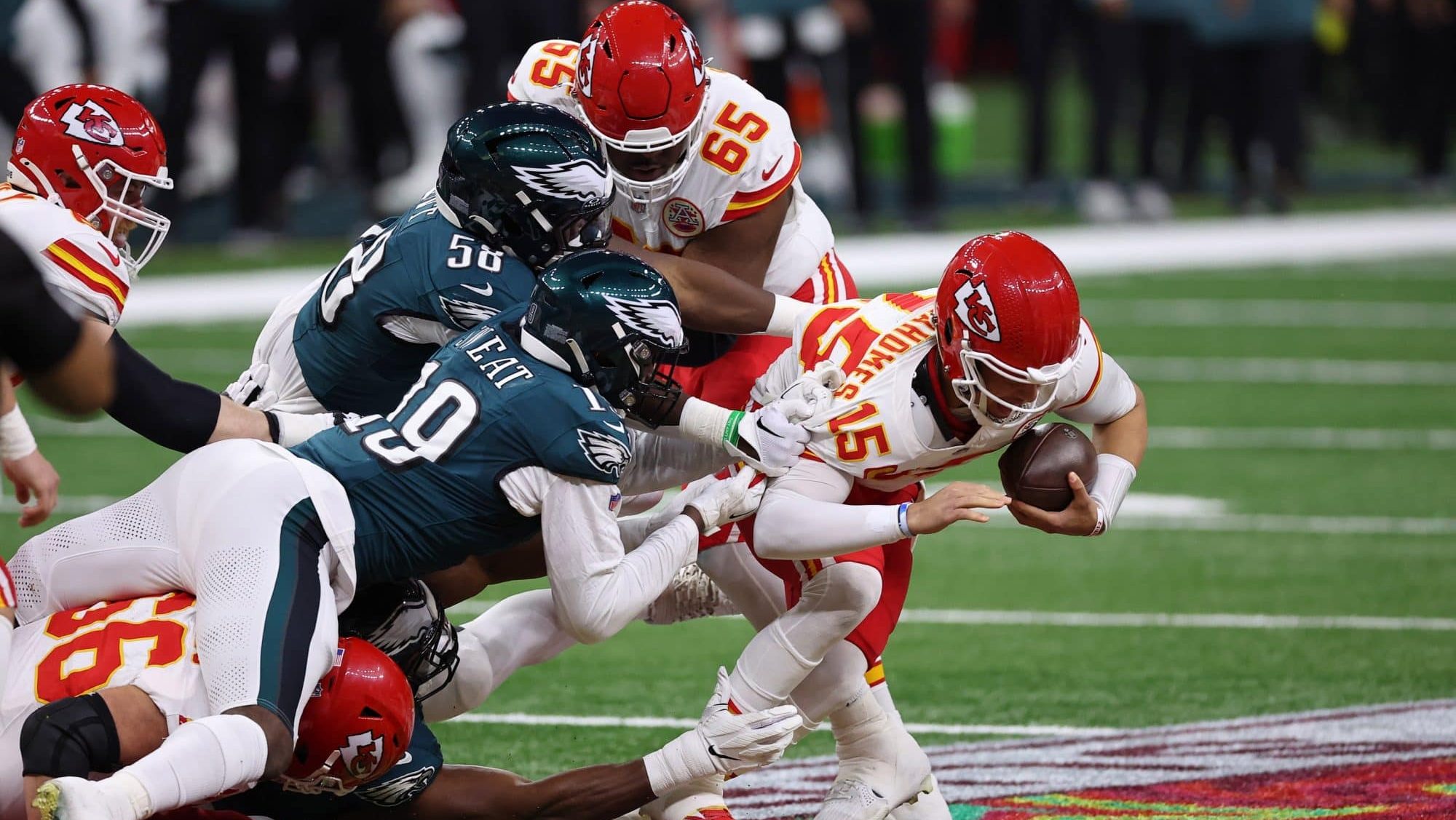 Feb 9, 2025; New Orleans, LA, USA; Philadelphia Eagles linebacker Jalyx Hunt (58) and linebacker Josh Sweat (19) tackle Kansas City Chiefs quarterback Patrick Mahomes (15) during the first half of Super Bowl LIX at Caesars Superdome.