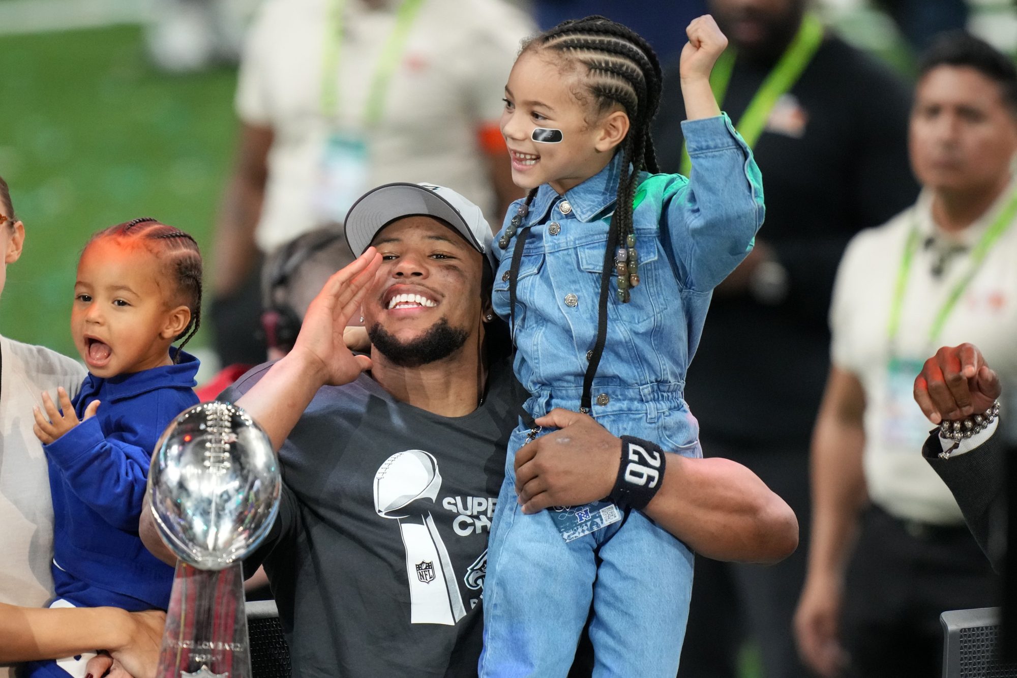 Feb 9, 2025; New Orleans, LA, USA; Philadelphia Eagles running back Saquon Barkley (26) talks to the media with his daughter, Jada, after defeating the Kansas City Chiefs in Super Bowl LIX at Caesars Superdome.