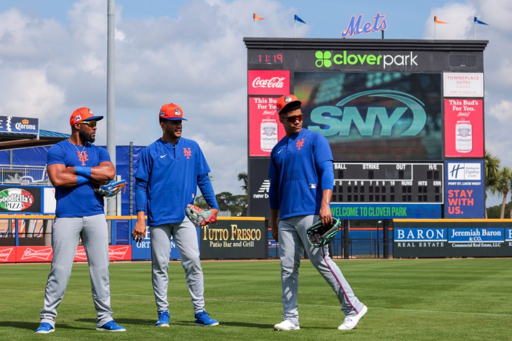 Feb 19, 2025; Port St. Lucie, FL, USA; New York Mets right fielder Juan Soto (right) talks to center fielder Jose Siri (center) and right fielder Starling Marte (left) during a spring training workout at Clover Park.