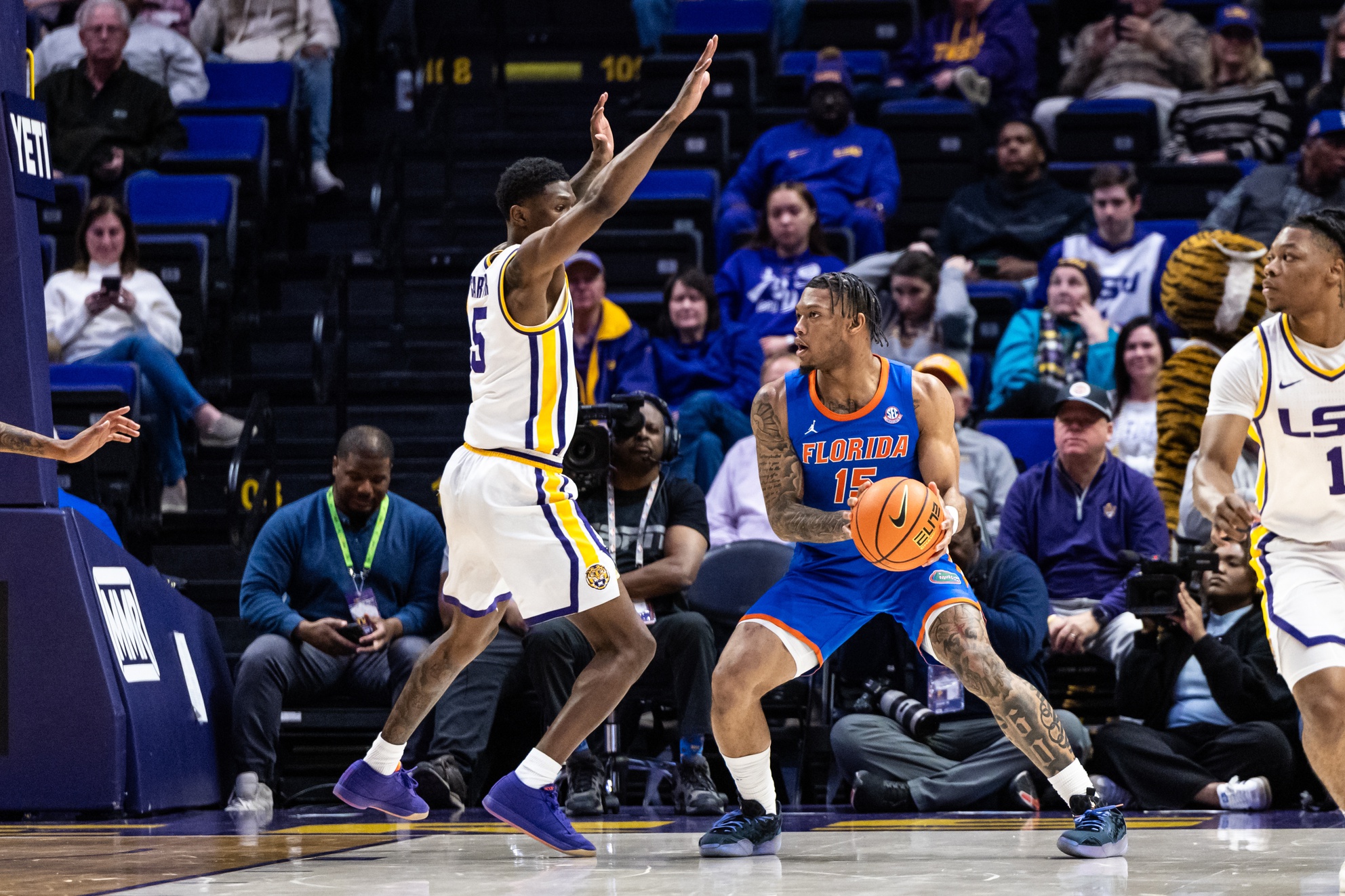 Feb 22, 2025; Baton Rouge, Louisiana, USA; Florida Gators guard Alijah Martin (15) dribbles against LSU Tigers guard Cam Carter (5) during the first half at Pete Maravich Assembly Center.