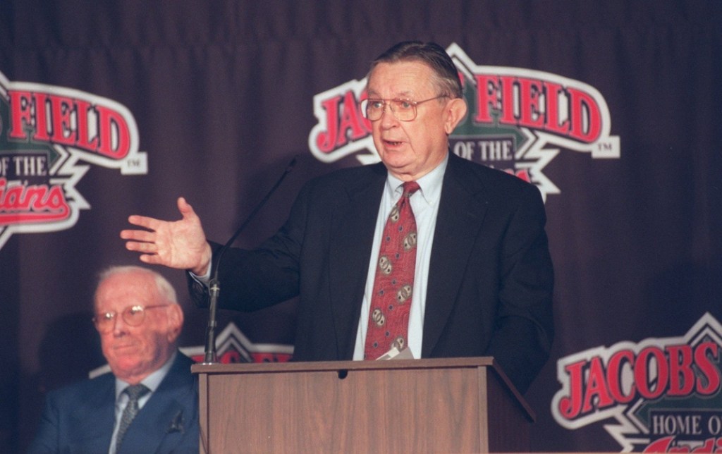 Larry Dolan (at podium) purchased the Cleveland baseball team from Dick Jacobs (in background) for $320 million.