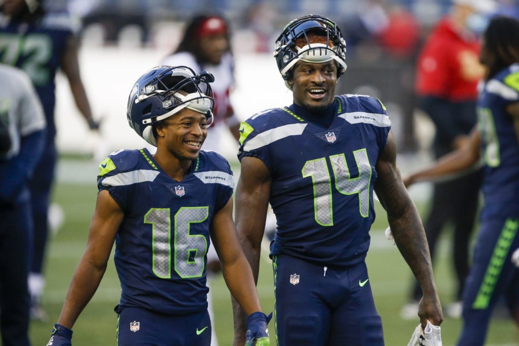 Nov 1, 2020; Seattle, Washington, USA; Seattle Seahawks wide receiver Tyler Lockett (16) and wide receiver DK Metcalf (14) return to the locker room following a 37-27 victory against the San Francisco 49ers at CenturyLink Field.