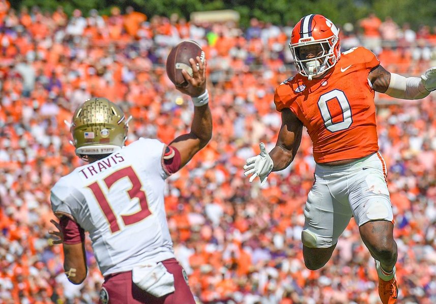 Clemson linebacker Barrett Carter (0) pressures Florida State University quarterback Jordan Travis (13) during the fourth quarter Sep 23, 2023; Clemson, South Carolina, USA; at Memorial Stadium.