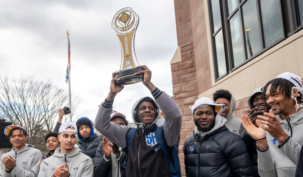 Apr 5, 2024; South Orange, NJ, United States; Pirates fans gather at Seton Hall University to welcome home the basketball team after they won the NIT championship. Kadary Richmond holds up the trophy as the team applauds.